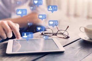 social media marketing image with a man tapping his tablet with his hands