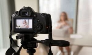 woman sitting down in front of camera - video production