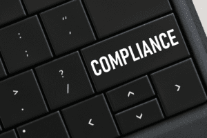 Keyboard with the word "Compliance" written on it